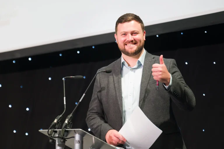 Speaker smiling on the seminar stage at the 2026 Sustainable Food Factory and Food+Beverage Engineering event.
