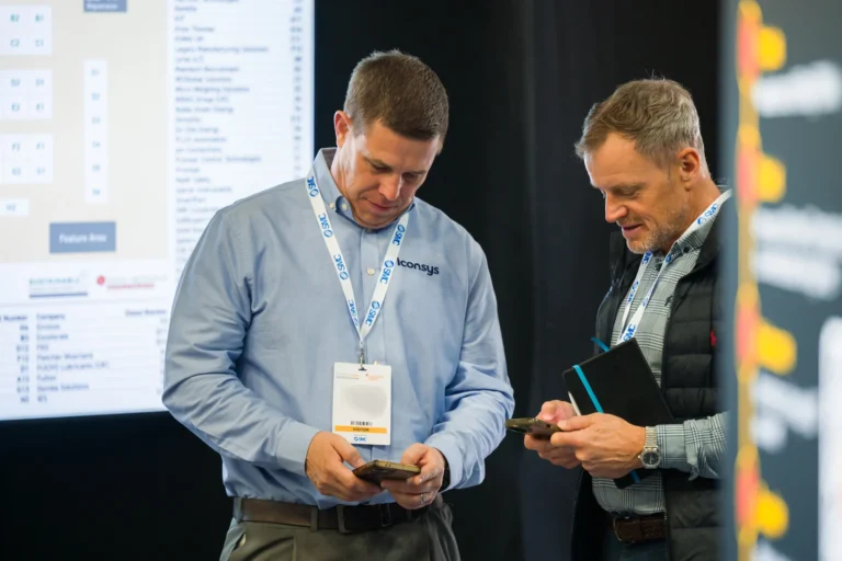 Two delegates reviewing information together at the 2026 Sustainable Food Factory and Food+Beverage Engineering event.